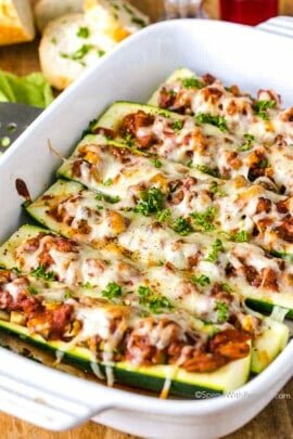 stuffed zucchini boats with baked cheese in a pan