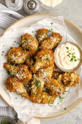 garlic parmesan wings with dip in a bowl