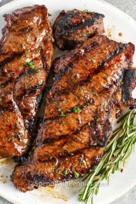 cooked marinated steaks on a plate