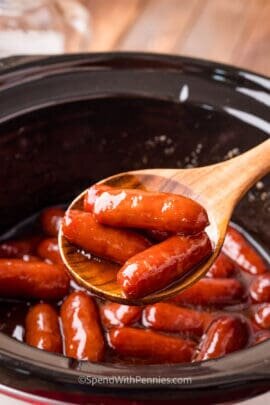 brown sugar bourbon smokies being scooped out of a slow cooker