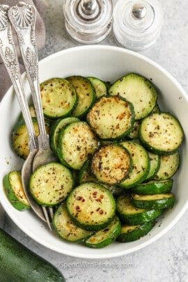 Sauteed Zucchini in a bowl with a fork and spoon