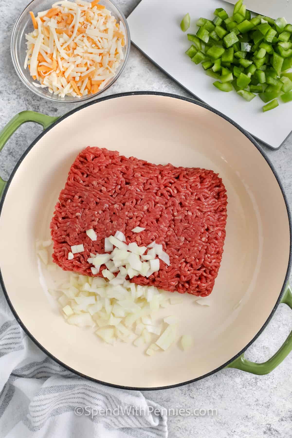 adding beef and onion to pan to make Taco Spaghetti